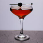 A Manhattan cocktail in a coupe glass.